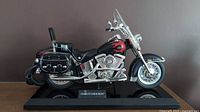 Full view of the vintage Harley Davidson motorcycle landline phone in black with red flames on a display base