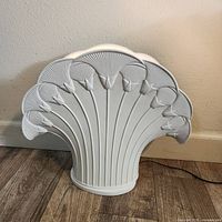 Front view of the large white ceramic Art Deco fan light showing detailed fan and floral motif design.