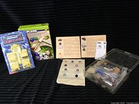 Full lot with gemstone samples, booklets, and reference sheets displayed on black fabric.