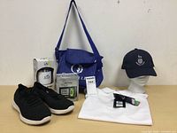 Full lot including shoes, bag, drink container, GPS device, shirt, and cap on mannequin head