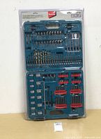 Front view of the full sealed accessory kit in its teal plastic case, showing all bits and sockets arranged neatly inside the case.