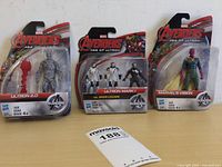 Front view of the three Marvel Avengers action figures in original packaging: Ultron 2.0 on the left, Ultron Mark I vs Iron Legion pack in the middle, Marvel's Vision on the right.