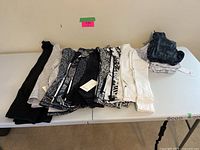 All 14 garments laid out side by side on a folding table