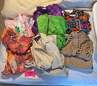 Full lot of vintage matching sets and swimsuits displayed folded and arranged