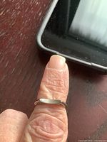 Ring worn on finger showing overall size and smooth band.