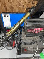 View of MotoMaster Eliminator power inverter and light stick with cords