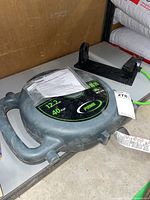 Prime retractable cord reel with handle, brand and length details visible, placed on tabletop with mounting bracket present.