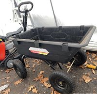 Front-left perspective of plastic tub, handle, and frame