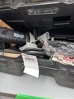 Joiner machine in open black carrying case with biscuits and MaxSold sale label.