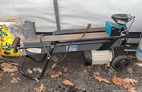 Full side view of horizontal electric log splitter showing frame, motor and splitting mechanism