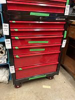 Front view showing all six red drawers, black frame and caster wheels