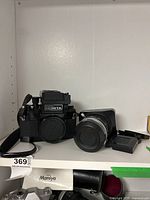 Overview shot of camera body, lens and covers