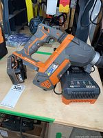 Drill, battery and charger on workbench