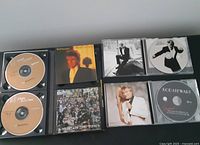 Four Rod Stewart CDs open showing discs and album artwork