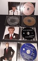 Five Rod Stewart CDs laid out showing some album covers and disc designs.