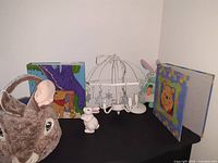 Overview of lot showing plush Peter Rabbit head basket, ceramic rabbit figurine, small plush rabbit, white umbrella ceiling lamp, and Winnie the Pooh binders.