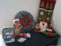 Photo showing full lot including wreath, stocking, ornaments, gingerbread plush toy, and cookie tin on a flat surface.