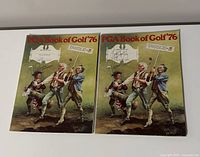 Two 1976 PGA Book of Golf copies placed side by side; visible front covers and signatures.