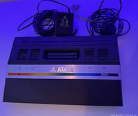 Full view of Atari 2600 console with power adapter and cables.