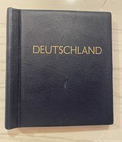Front cover of dark blue album with gold embossed text 'DEUTSCHLAND'.