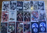 Image showing multiple Marvel comics including Wolverine variants and Death of Wolverine series, Thor, X-Men issue, Civil War II #3, and Amazing Spider-Man variants, all boarded and bagged.