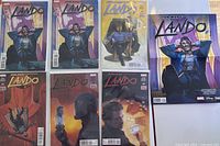 Front view of series issues and extras including the full set issues 1-5 and extra issue #1 alongside a poster, all bagged and boarded.