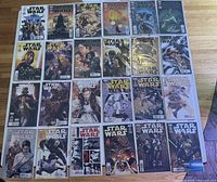 Photo showing multiple issues of Marvel Star Wars comics laid out in rows, featuring cover art with characters and scenes from Star Wars universe.