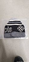 Black, gray, and white Columbia knit winter hat showing the Columbia logo