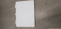 White rectangular jewelry craft surface lap tool on floor.