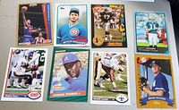 Photo of 8 sports cards from basketball, baseball, and football featuring various players in vintage style.