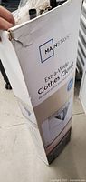 Box showing Mainstays branding and product name Extra-Wide Clothes Closet with slight damage on corner