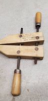 Top view of vintage Jorgensen wood screw clamp showing adjustable wooden body, metal screws and wooden handle grip.