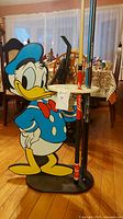 Front and side views of Donald Duck pool cue holder with 3 cue sticks, showcasing Coca Cola branding on wooden cue and colorful Donald Duck figure.