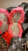Pink feathered butterfly wings and other fabrics visible