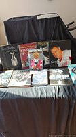 Photo showing 11 assorted hockey books, including Lord Stanley's Cup, NHL Stanley Cup Centennial, Don Cherry's Mission Possible, Gordie Howe, Mario Lemieux, and hockey chronicles with player action photos.