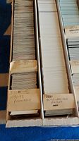 Top view of hockey cards in a long box showing dividers labeled 1991-92 Pinnacle, 1992-93 Upper Deck, 92-93 Ultra Deck Extras.