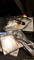 Sony PlayStation 1 console with AV cables and game cases including PS2 and PS4 games