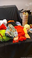 Various colorful fabric pieces and large white batting bags visible with a cylindrical container of knitting needles.