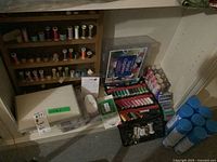 Wide view of wooden thread rack on floor next to plastic and fabric organizers and row of spray starch cans