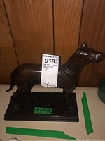 Front profile view of the dog figurine on base