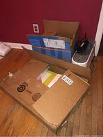 Three unopened cardboard boxes containing assorted GO! Qube dies, templates and patterns.