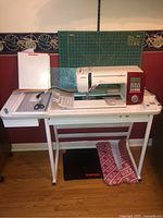 Wide view of sewing machine on table with accessories