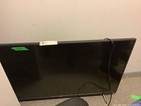 Front view of LG 43 inch flat screen TV in black, with power cord attached.