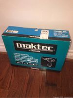 Original unopened box of Maktec cordless driver drill MT063SK2. Shows brand, model, specs, and image of drill on box.