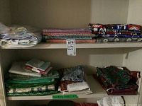 Shelves filled with quilting fabrics, showing a range of colors and patterns, folded stacks of fabric with a label “Quilting Fabric”