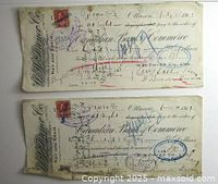Front of two early 1900s cancelled, stamped cheques from W.H. Dwer Co., with visible handwriting, stamps, and red postage stamps.