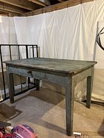 Full front three-quarter view of table showing overall shape, paint wear and single drawer