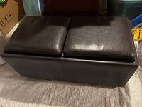 Front view of the double faux leather ottoman with two padded top cushions side by side.