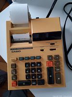 Top view of Casio FR-1011 electric printing calculator showing all keys and paper roll.