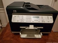 Image showing front view of HP Officejet Pro L7580 all-in-one printer with paper output tray open